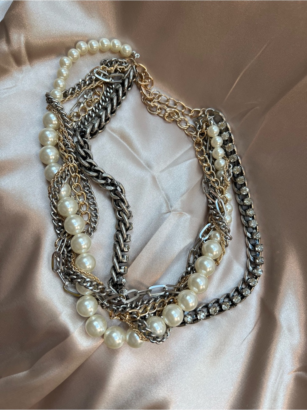 Multi strand multi color 16” necklace. Has white, gold, silver strands.